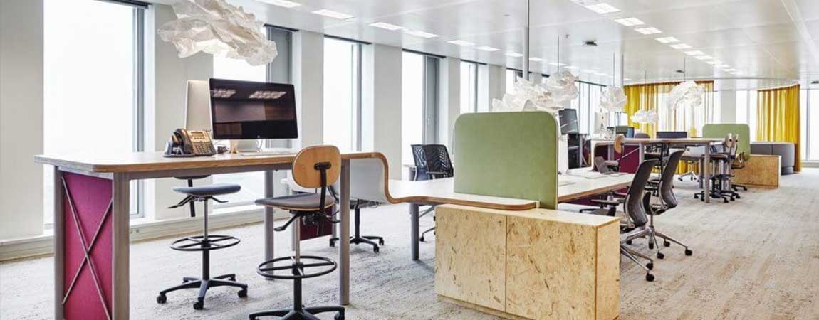 Dayliter shades block glare from office windows while filling the room with reflected light